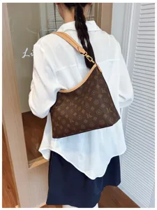 Stylish brown monogram hobo shoulder bag for women, chic commuting casual tote handbag.