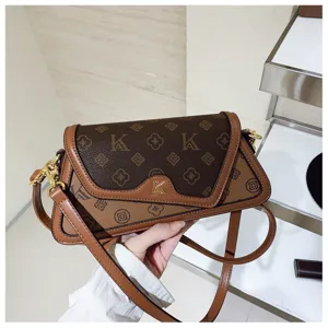 Detailed view of women's fashion monogram shoulder bag, chic contrast color underarm crossbody bag.