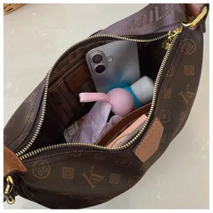 Detail view of the brown monogram hobo crescent bag interior capacity showcasing daily storage essentials.