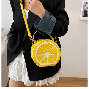 Graziosa borsa a tracolla tonda a forma di limone giallo con manico e tracolla donna.