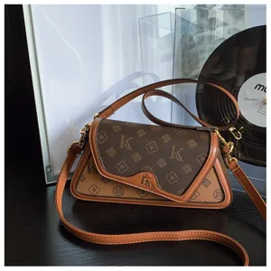 Detailed view of women fashion monogram underarm shoulder bag with brown color block design.
