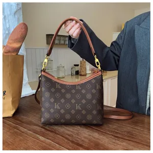 Detailed view of the stylish brown monogram shoulder bag showcasing exquisite floral and letter pattern.
