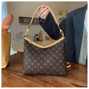 Stylish brown monogram shoulder bag for women, classic hobo commuting handbag with top handle.