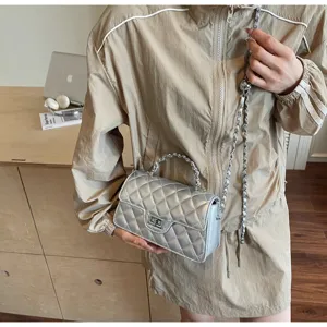 Chic quilted chain shoulder bag for women, versatile metallic silver crossbody handbag.