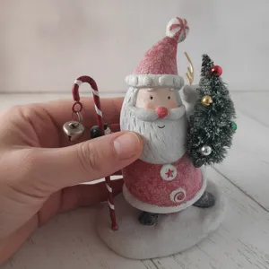 Resin Santa Claus figurine with candy cane staff and mini Christmas tree detail for holiday decor.