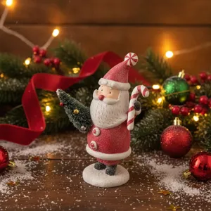 Resin Christmas Santa Claus figurine holding candy cane and tree holiday desktop ornament.