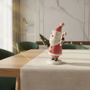 Christmas resin Santa Claus figurine with candy cane and tree, tabletop holiday decor.