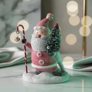 Christmas resin Santa Claus figurine holding candy cane and mini tree for holiday home decor
