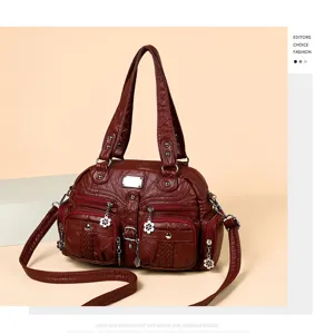 Detailed view of the vintage washed PU leather tote bag, featuring multi-pockets and charms.