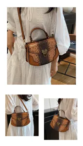 Closeup view of the stylish snakeskin shoulder bag showcasing metal lock and strap details.