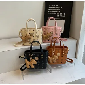 Korean style monogram bucket bag with cute puppy charm, stylish PU leather crossbody bag.