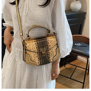 Detailed view of the luxury fashion snakeskin shoulder bag, stylish handbag for women.