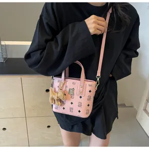 Pink monogram tote bag detailed view showcasing stylish bucket bag design with cute charm.