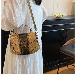 Chic snakeskin print crossbody bag with metal clasp and chic top handle for women daily wear.