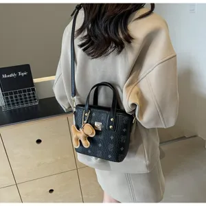 Korean style black printed bucket bag with top handle, shoulder strap and cute dog charm.