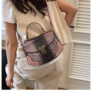 Fashion snakeskin pattern women shoulder bag with top handle and pink side panel design.
