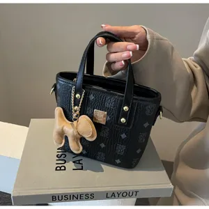 Women's black PU leather bucket bag with cute dog pendant, korean style fashion shoulder handbag.