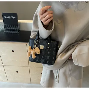 Korean style printed bucket bag with cute dog pendant, fashionable shoulder crossbody tote.
