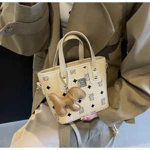 Detail view of trendy Korean print bucket bag, featuring cute bear pattern and chic charms.