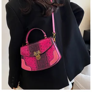 Chic pink snakeskin crossbody bag for women, stylish shoulder handbag with metal lock and studs.