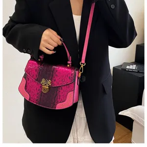 Stylish pink snake texture crossbody handbag with top handle and elegant hardware for women.
