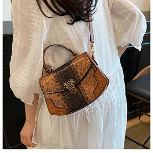 Detailed view of the stylish textured shoulder handbag featuring golden hardware and top handle.