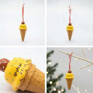 Detailed view of resin mango ice cream cone Christmas ornament with handwritten model text.