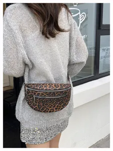 Detailed view of the stylish leopard print crossbody waist bag with zipper pockets.
