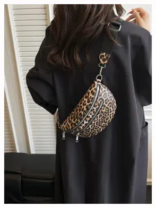 Detailed shot of a stylish leopard print crossbody waist bag with wide strap and zip closures.