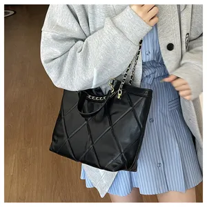 Black quilted tote bag with chain strap, large capacity commuter handbag for women details.