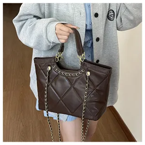 Stylish brown quilted tote bag for women with chain straps and large capacity commute use.