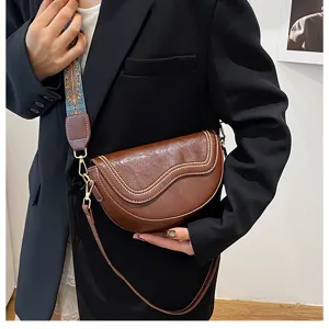 Retro brown women saddle bag with chic wide strap, stylish PU leather shoulder crossbody bag.