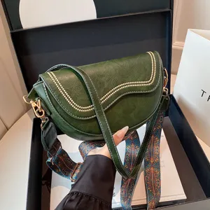Vintage green saddle bag for women, stylish underarm shoulder bag with wide strap.