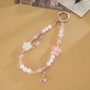 Detailed close-up of pink beaded phone charm with star and flower pendants, stylish accessory.