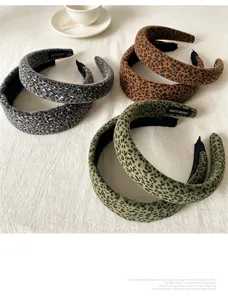 Vista detallada de diadema ancha con estampado de leopardo, accesorio de terciopelo chic.