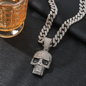 Detailed shot of hip-hop rhinestone skull pendant necklace with Cuban chain texture close up