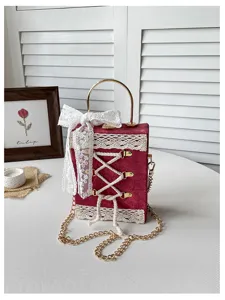 Lolita style red velvet box handbag with white lace cross lacing and gold chain strap.