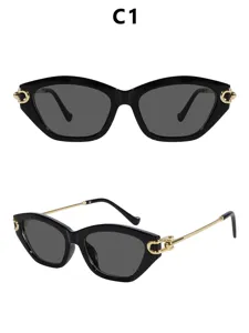 Dames zonnebril kattenoog luxe mode zwart montuur gouden metalen pootjes chique trendy stijl