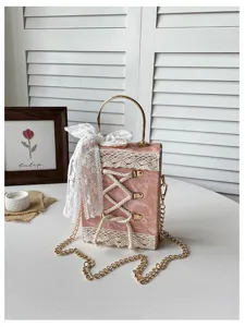 Pink lolita lace-up book box shoulder bag with gold chain and handle detailed view.