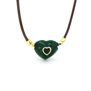 Green heart stone pendant necklace with brown wax cord, stylish gold accent jewelry.
