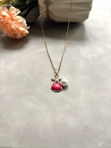 Gros plan détail du collier pendentif étoile de mer coquillage perle série océan.