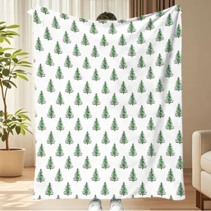 Cozy fleece blanket with green pine pattern, soft flannel fabric, warm bed cover for winter.