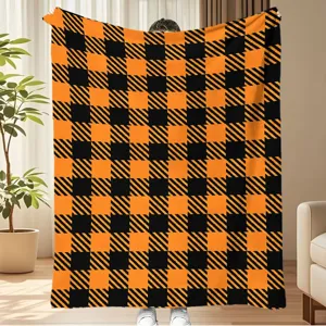 Cozy orange black plaid flannel blanket, thick soft warm throw for autumn winter home decor.