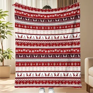 Festive red and white Christmas fleece blanket with traditional Nordic snowflake patterns.