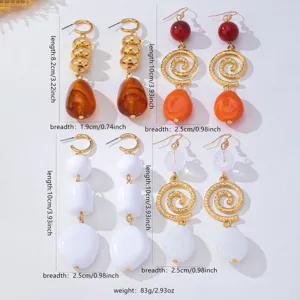 Vintage long amber and white drop earrings set featuring elegant golden spiral metal accents.