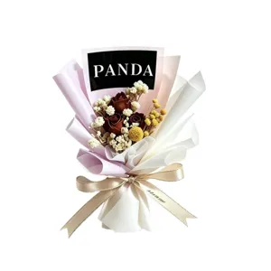 Mini Trockenblumen Strauß Handgemacht Geschenk verpackt in rosa und weißem Papier.