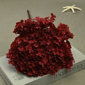 Detailed view of dark red preserved hydrangea single branch for handmade floral decor.