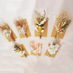 Detailed view of assorted mini dried flower bouquets with kraft paper cards for decor.