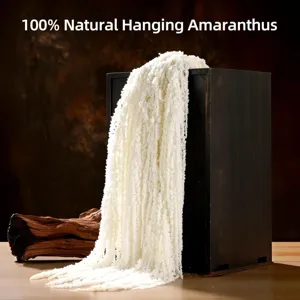 Close-up detail of white hanging amaranthus dry flower in floral arrangement scene.