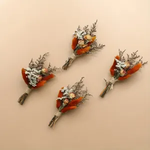 Mini dried flower boutonnieres detail shot, featuring natural orange and white plants for wedding.